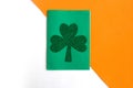 Happy St. PatrickÃ¢â¬â¢s Day. Three leaf clover on white, green and orange background.